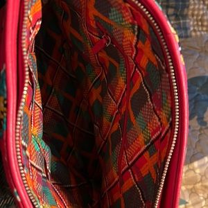 Festive Vera Bradley bag with cross body straps or carry straps.